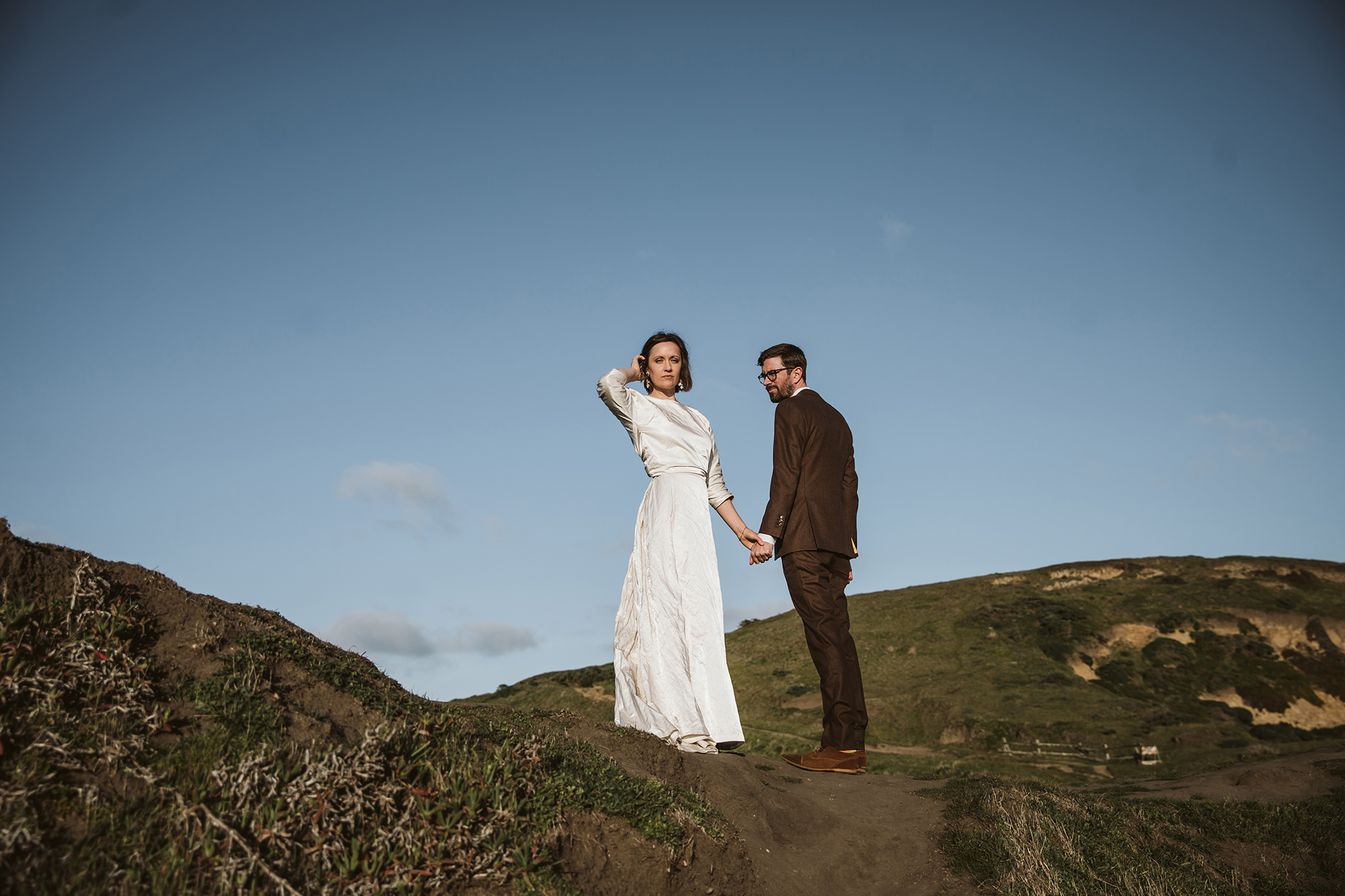 Bride taking in the scene atop the cliff during their Point Reyes elopement.