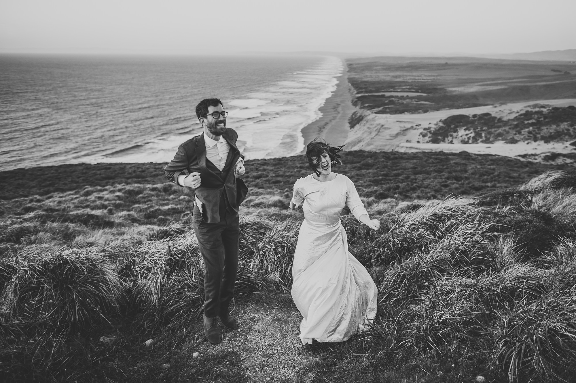 Bride and groom jump up and down to keep warm ..and just having fun during their Point Reyes elopement.
