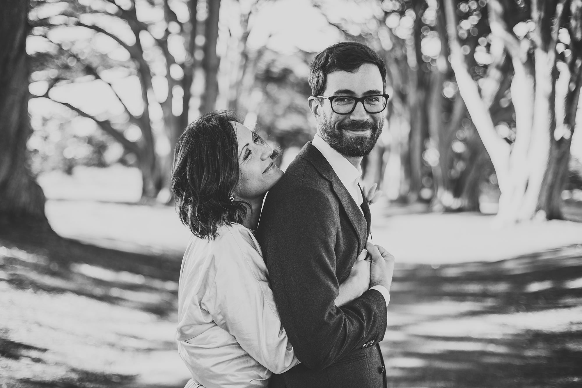 Bride and Groom hugging under the Cypress Tree Tunnel.