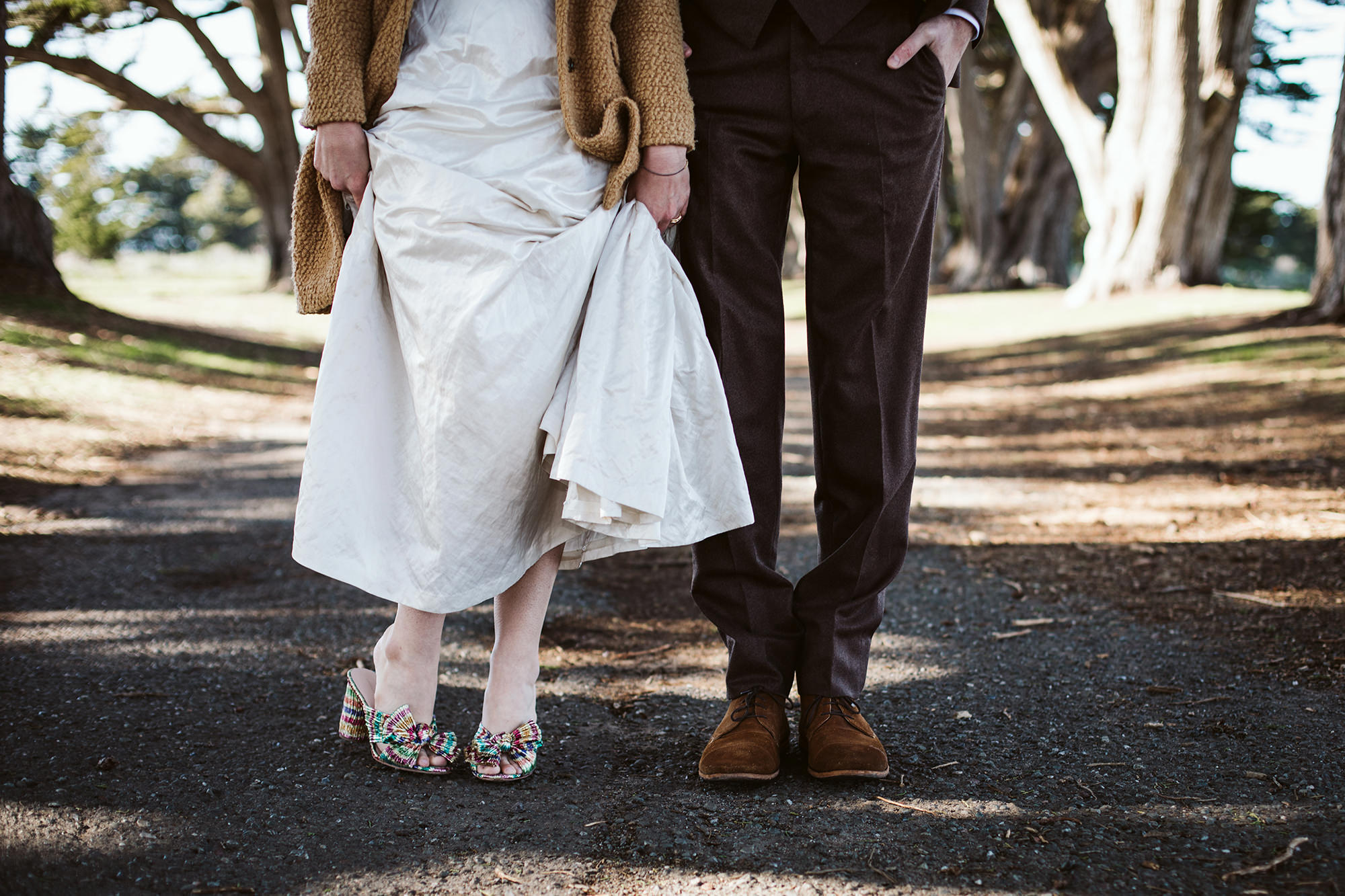 Checking out the bride and groom's snazzy shoes the Cypress Tree Tunnel for Point Reyes Elopement.