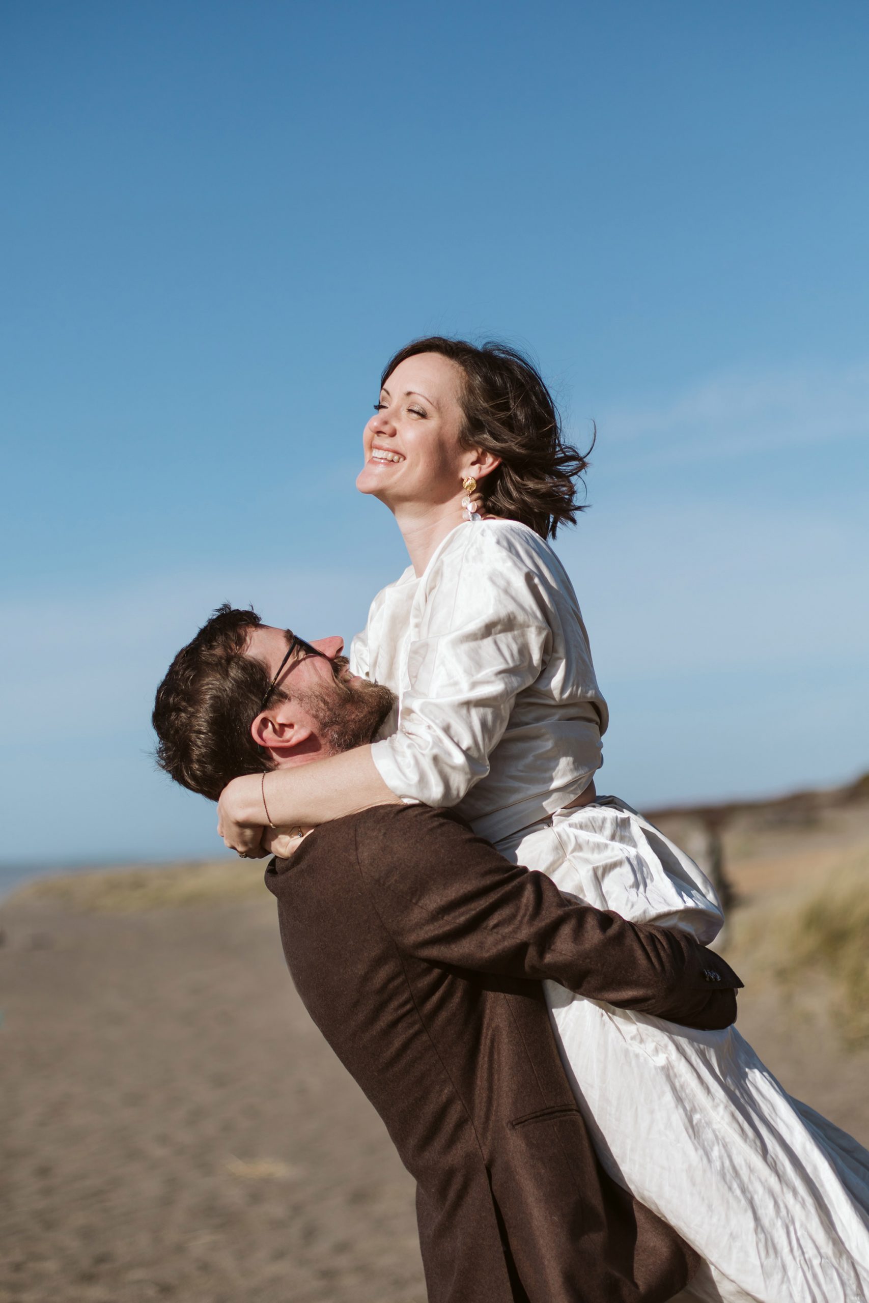Bride and groom playing during an adventurous California elopement.