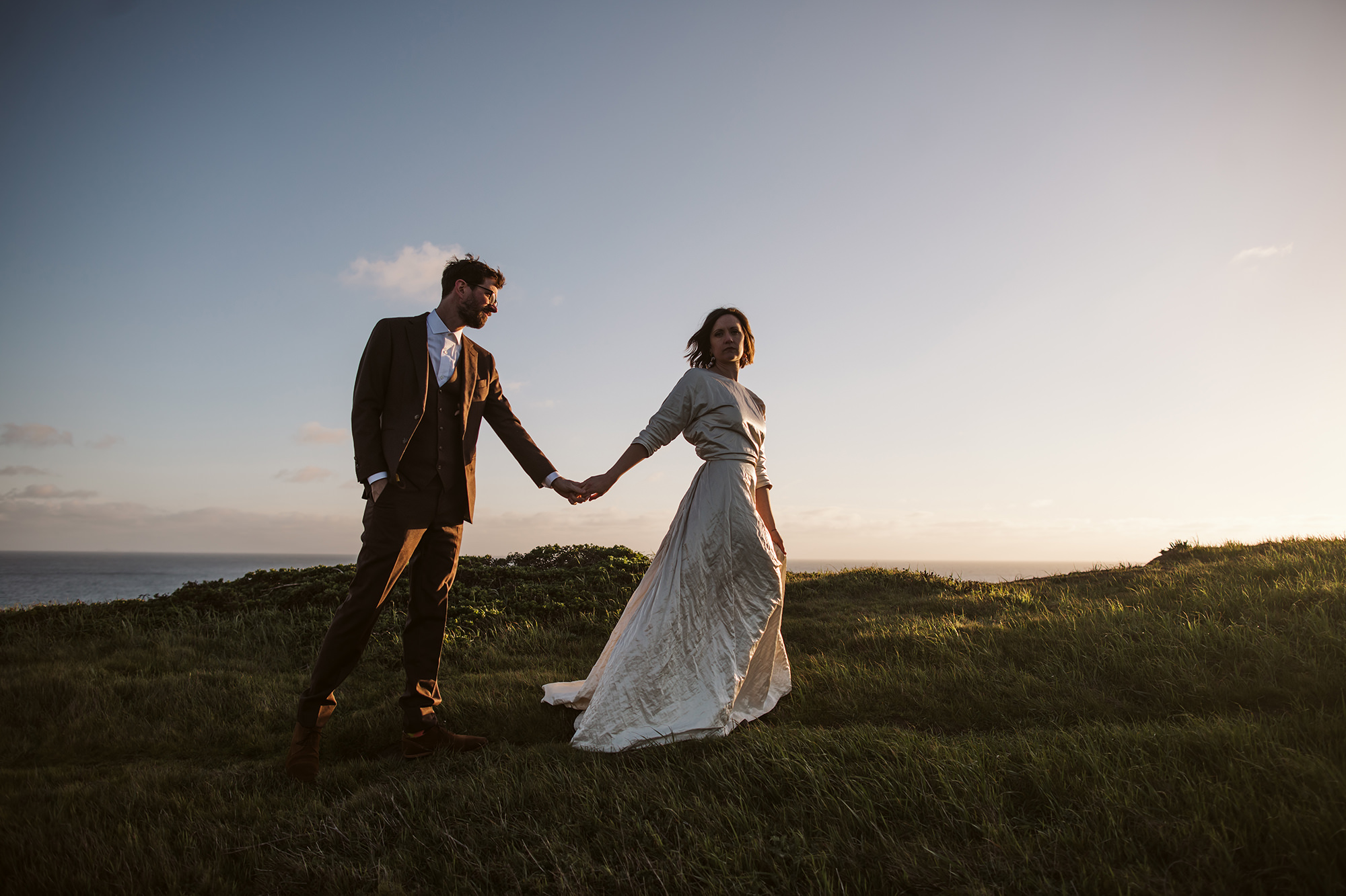 Bride and groom walking into the sunset during their Point Reyes elopement.