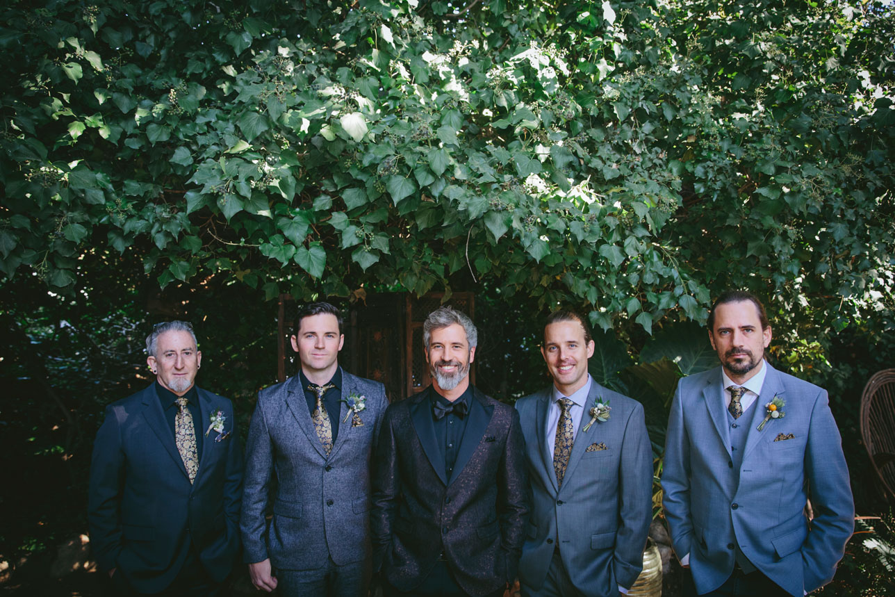 Groom and groomsmen group photo under the lush greenery