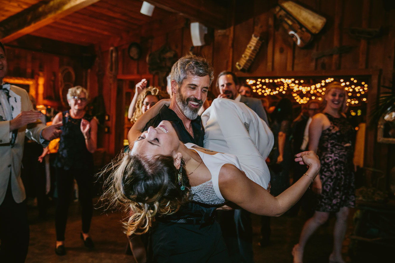 Groom lifts up bride while dancing at Carmel Wedding reception