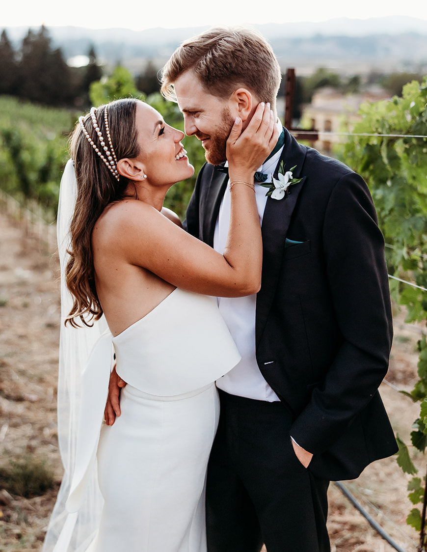 Northern California Vineyard Wedding- just married couple Northern California Vineyard Wedding at sunset - Bride touches groom's cheek
