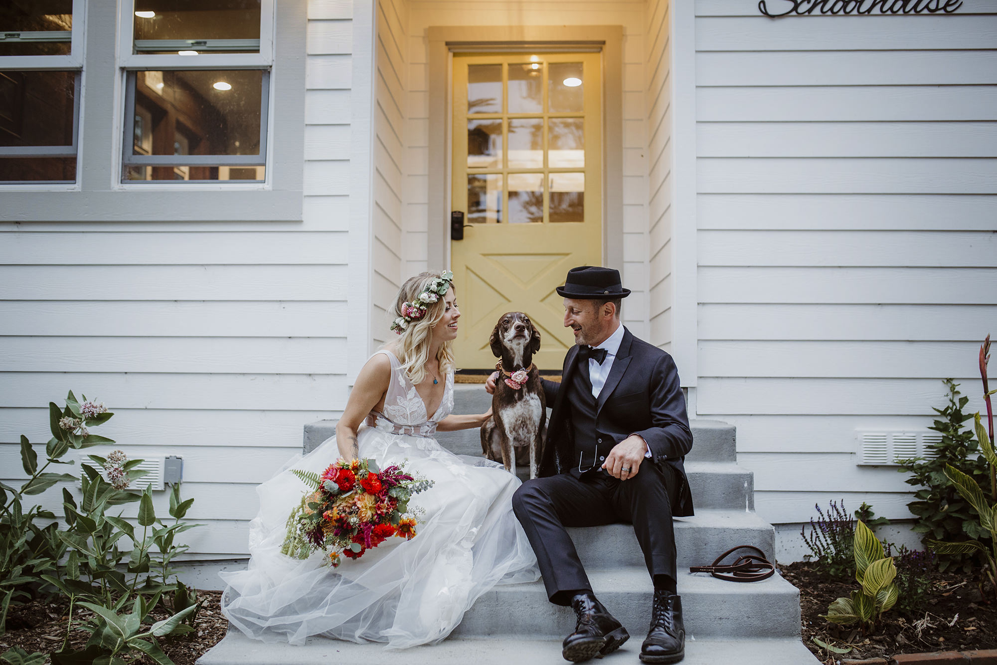 Couple takes a moment with their puppy at their Stemple Creek Ranch Wedding.