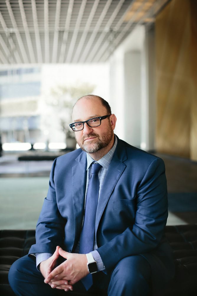 Professional businessman in suit with glasses for BH branding website.