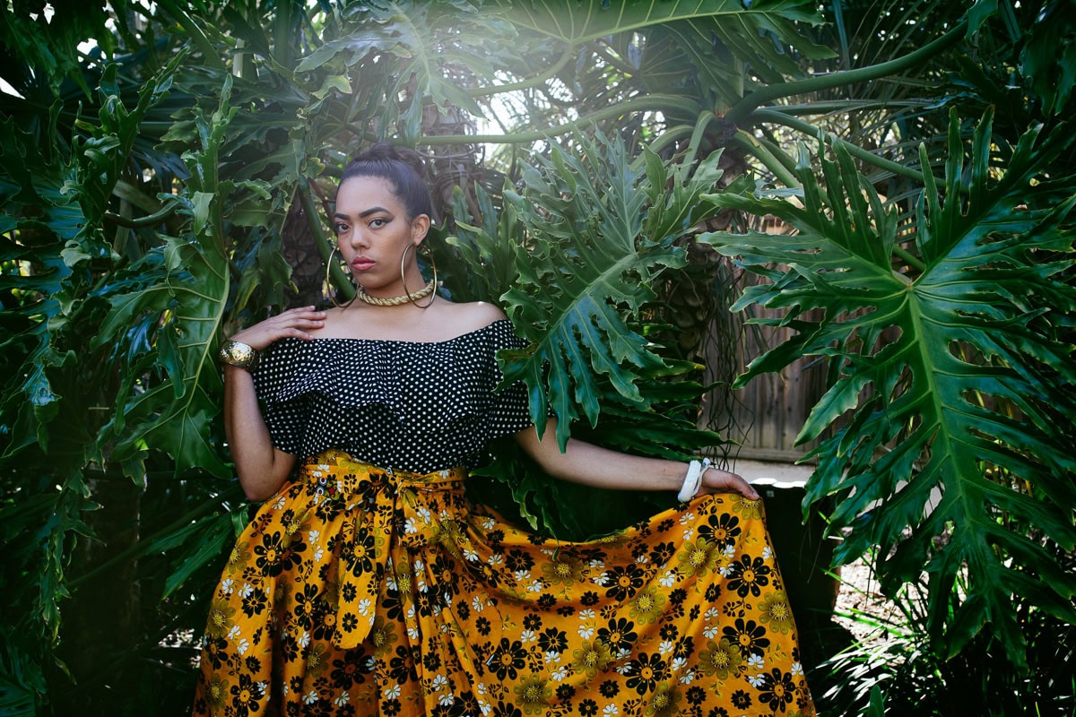 Woman posing among lush tropical plants for branding photoshoot for designer by Becca Henry Photography