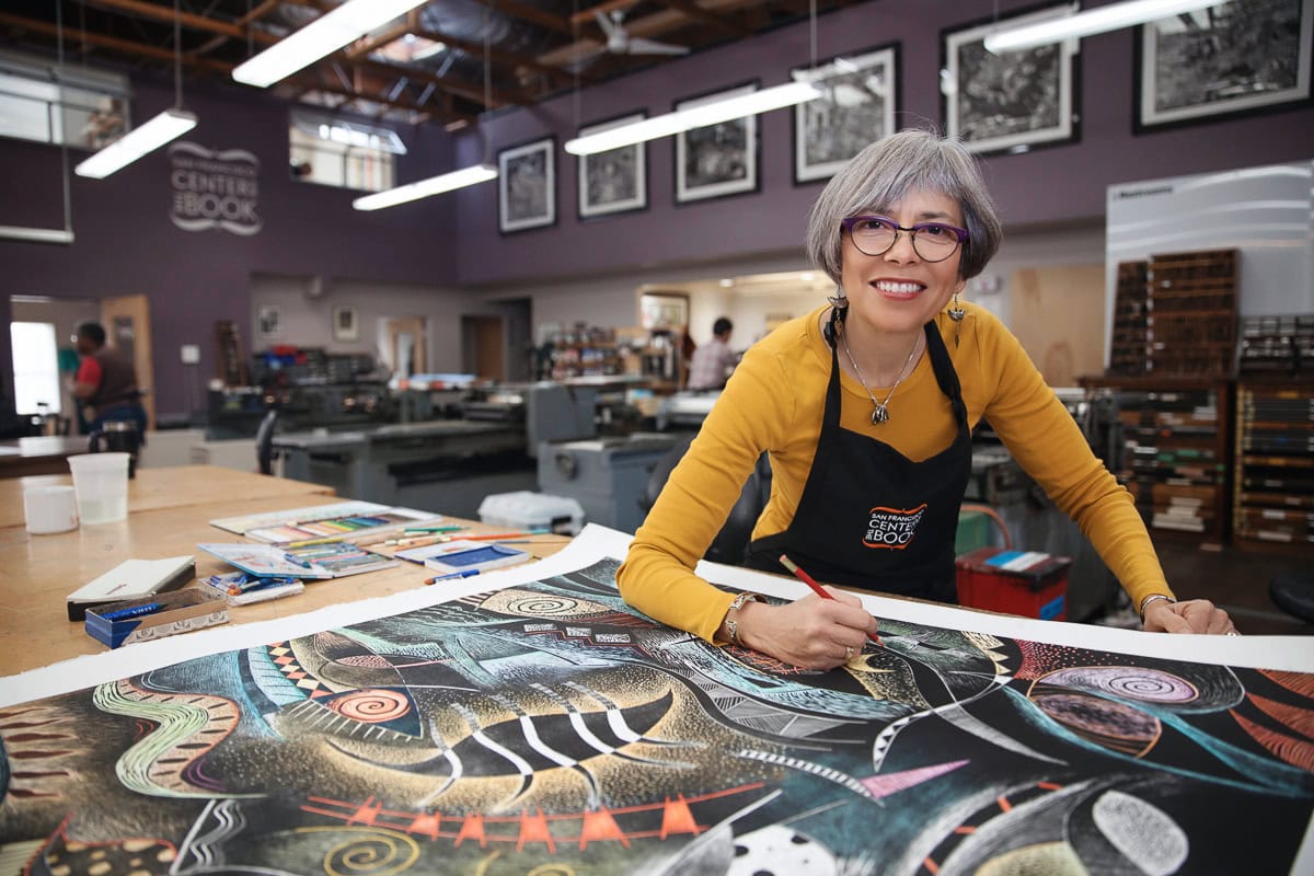 Creative woman painting colorful abstract art in a studio setting.