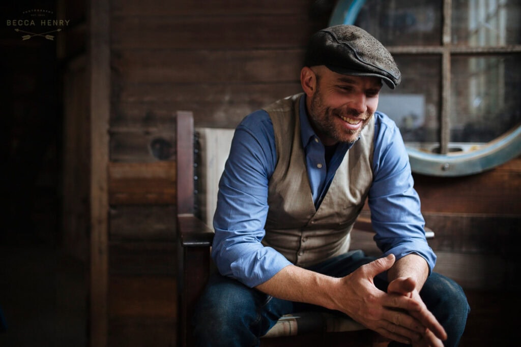 Smiling man in casual attire with vintage background for branding photography.