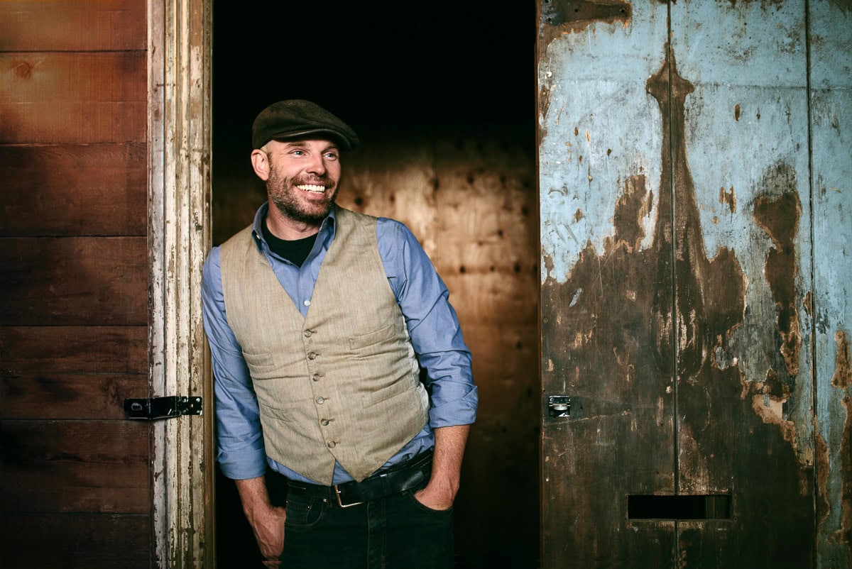 Creative professional smiling in rustic setting.