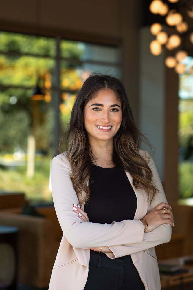 Confident businesswoman smiling indoors, professional headshot for branding.