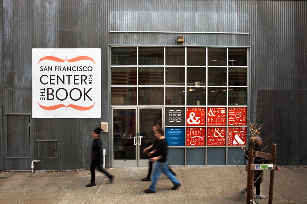 Exterior view of San Francisco Center for the Book with promotional posters. Branding photography