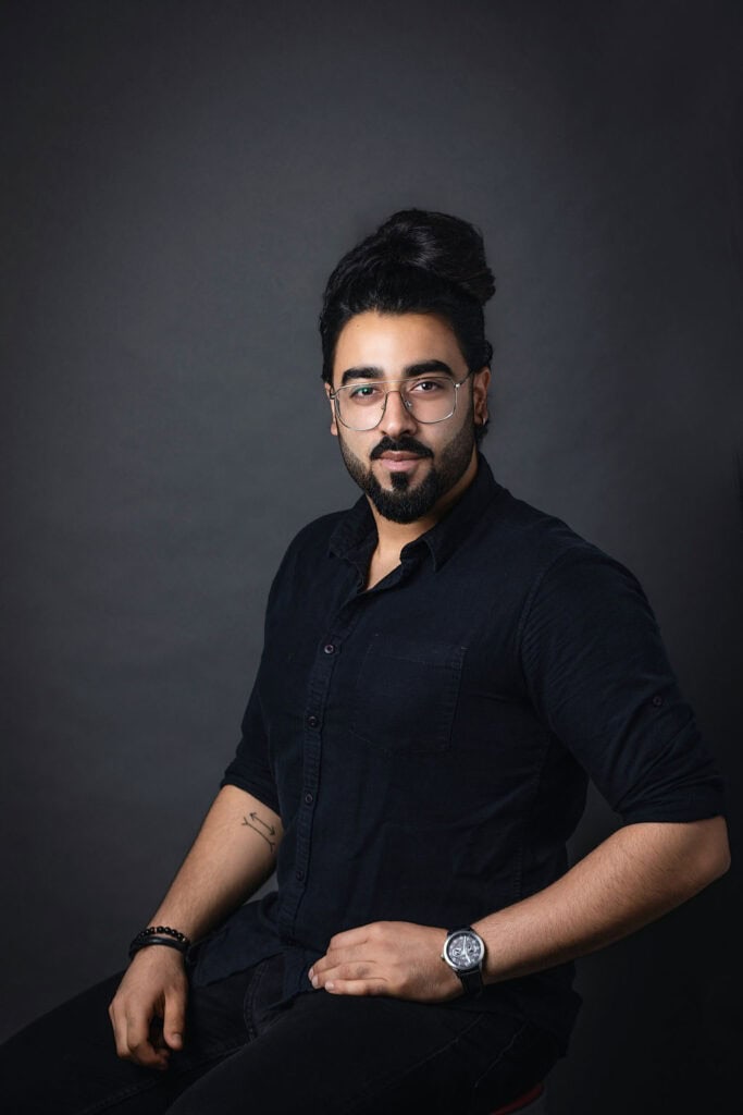 Professional portrait of a man with glasses and dark hair for branding and corporate photography.